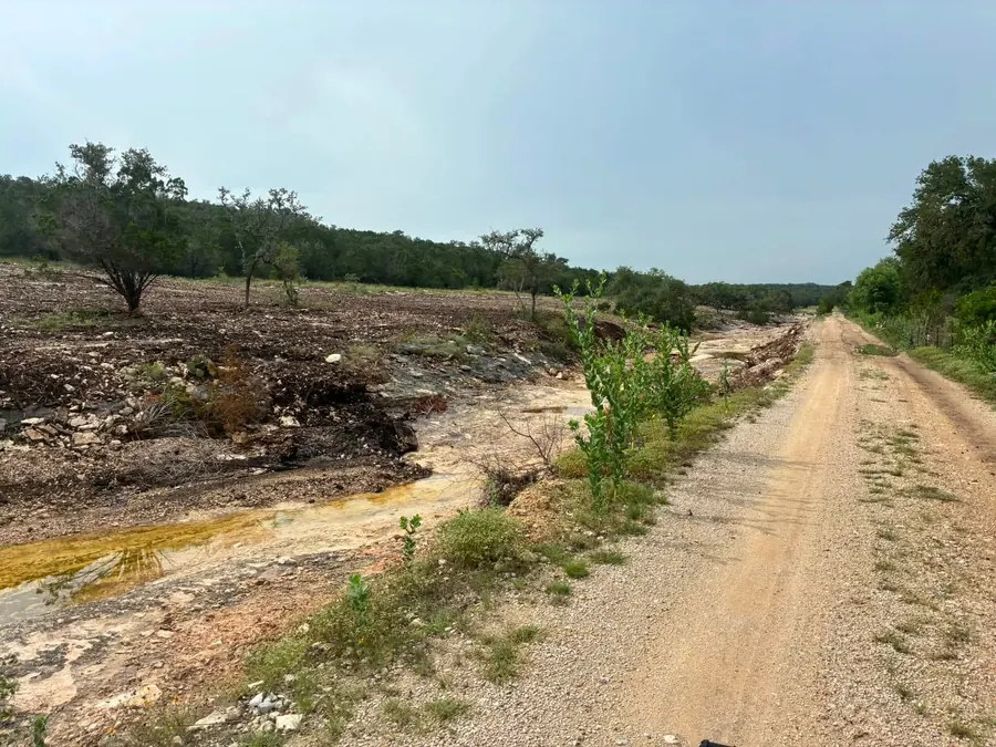 Caliche ranch road running beside freshly cleared ground